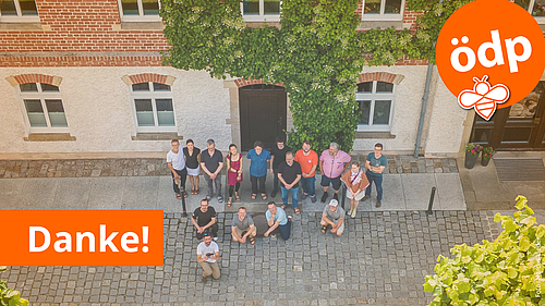 Luftaufnahme. Gruppenfoto von 16 Mitgliedern der ÖDP Sachsen vor einem Gebäude. Oben rechts das ÖDP Logo. Unten links Schriftzug "Danke!".